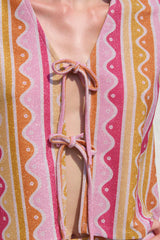Close-up of a colorful striped garment with a tie detail.