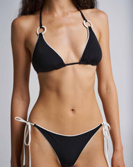 Black bikini with white accents on a plain background